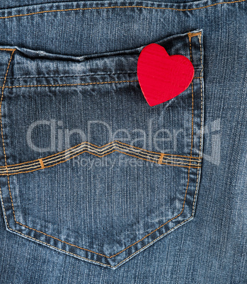 small red heart in the back pocket of blue jeans