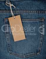 empty rectangular brown paper tag on blue jeans