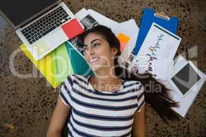 Woman lying on documents in office