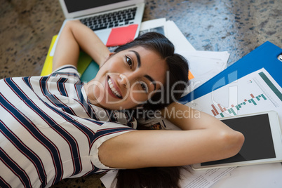 Woman relaxing on documents at office