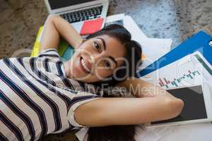 Woman relaxing on documents at office