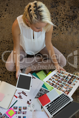 Young woman holding documents at office