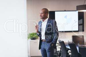 Businessman speaking at mobile phone standing in the office