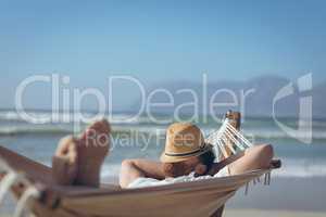 Man relaxing on hammock at beach