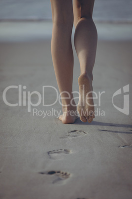 Woman walking on sand at beach