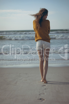 Woman walking on sand at beach