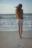 Woman walking on sand at beach