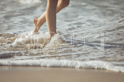 Woman walking along the ocean at the beach