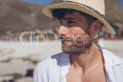 Man looking away standing at beach