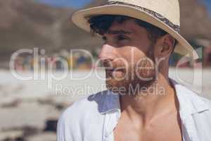 Man looking away standing at beach