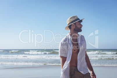 Handosme man standing at beach