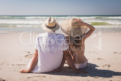 Couple relaxing at beach on a sunny day