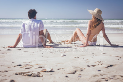 Couple relaxing at beach on a sunny day