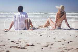 Couple relaxing at beach on a sunny day