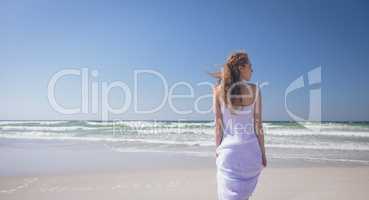 Young woman standing at beach on a sunny day