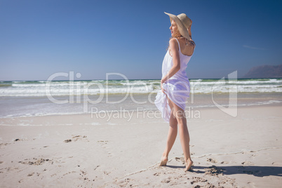 Beautiful woman giving pose while standing at beach