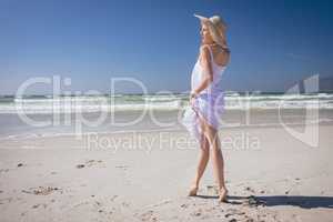 Beautiful woman giving pose while standing at beach