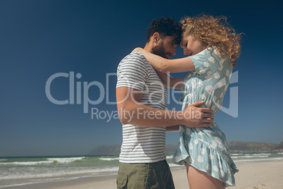 Young couple standing at beach on a sunny day