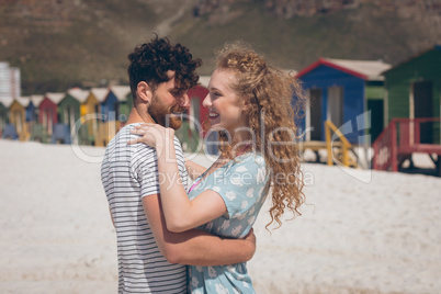 Happy romantic couple dancing at beach on a sunny day