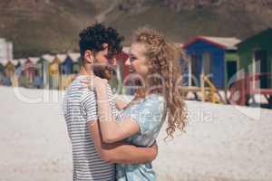 Happy romantic couple dancing at beach on a sunny day