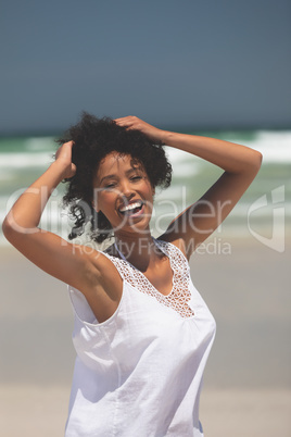 Beautiful woman giving pose while standing at beach