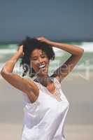 Beautiful woman giving pose while standing at beach