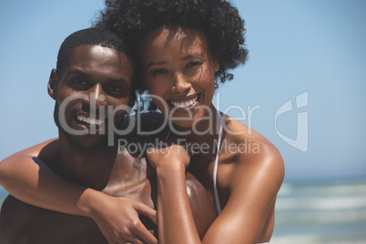 Happy couple standing at beach