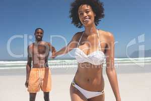 Man holding hand of woman at beach