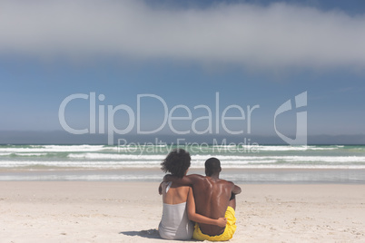 Couple relaxing at beach on a sunny day