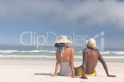 Couple relaxing at beach on a sunny day