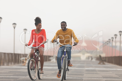 Couple riding bicycle at promenade on a sunny day