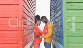 Romantic couple embracing each other in middle of beach hut