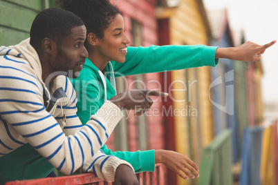 Couple interacting with each other at beach hut