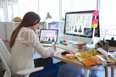 Female fashion designer working at desk in a modern office