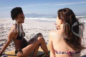 Young women interacting with each other on the beach