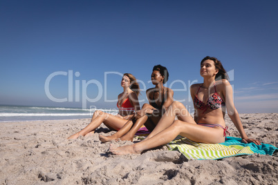 Beautiful young women relaxing on beach in the sunshine