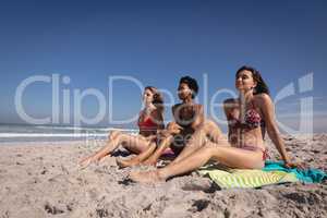 Beautiful young women relaxing on beach in the sunshine