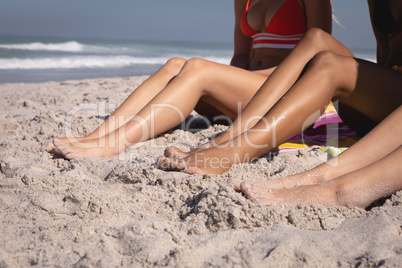 Young women relaxing on beach in the sunshine