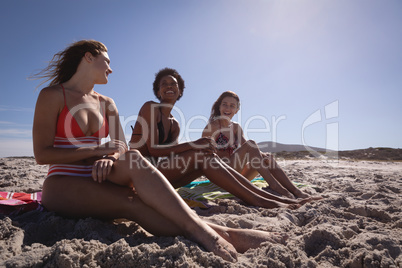 Happy beautiful young women relaxing on beach in the sunshine