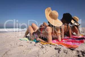 Beautiful young women lying and relaxing at beach in the sunshine