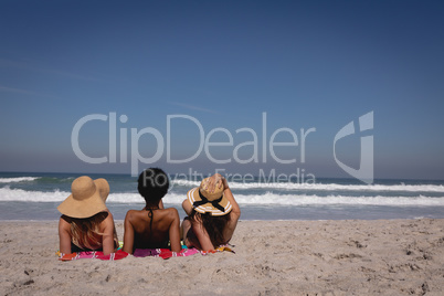 Beautiful young women lying and relaxing at beach in the sunshine