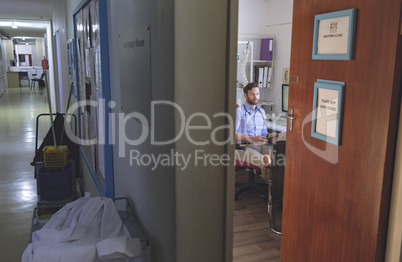 Male doctor interacting with patient inside clinic room