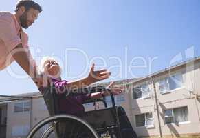 Male doctor talking with disabled senior patient women in wheelchair