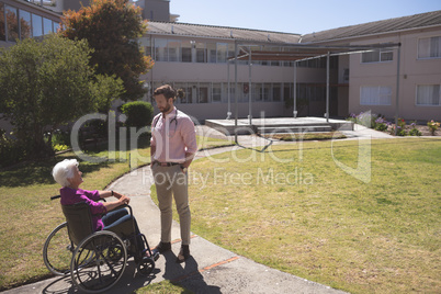 Male doctor and senior female patient interacting with each other