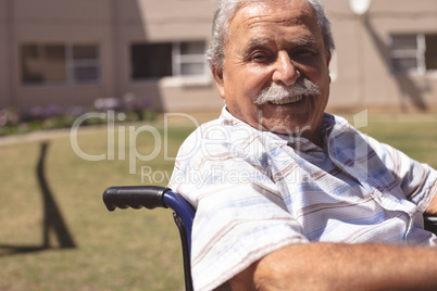 Senior man in wheelchair smiling at the camera