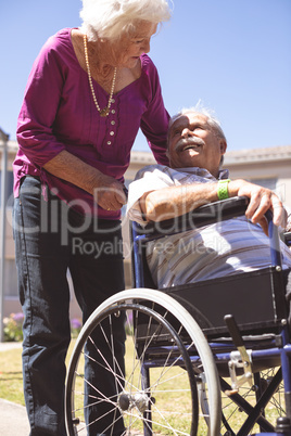 Senior couple interacting with each other in nursing park