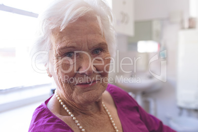 Happy senior woman smiling while she is sitting at nursing home