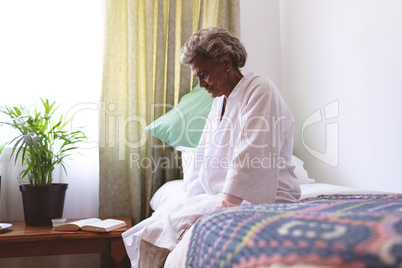 Senior woman sitting upset in nursing home