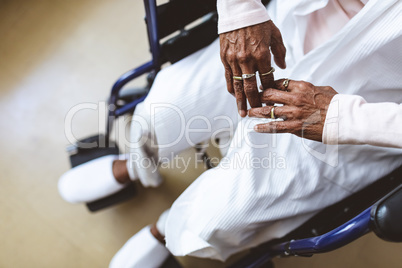 Senior woman sitting on wheelchair at nursing home