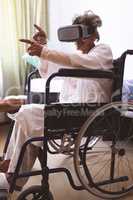 Senior woman using virtual realty headset at nursing home
